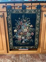 Full view of tapestry hung on cabinet door