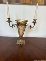 Front view showing brass vase, cut glass insert, and two candle arms with tapers