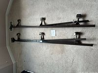 Full view of both metal side rails with casters and headboard brackets