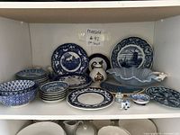 Overall view of assorted blue and white porcelain pieces on shelf