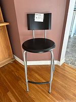 Front view of stool showing seat, backrest and legs