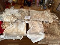 Overview of assorted crocheted linens on tabletop
