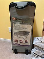 Front view of Ozark Trail folding queen cot in carry bag showing product label