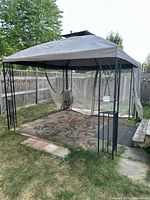 Full view of assembled gazebo showing canopy, frame and mesh curtains