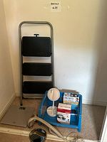Corner view showing ladder, scale, basket with medical devices, mirrors