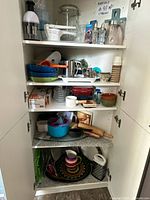 Full cabinet view with multiple shelves of assorted kitchen items