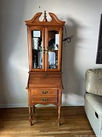 Front view showing entire secretary desk with glass hutch and drop-front