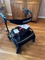 Side view of Human Care nEXus 3 rollator showing seat, basket, backrest with branding