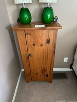 Front view of pine cabinet with single door