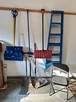 Overview of shovels, spades, ladder and chair