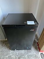 Closed black Arctic King chest freezer front view