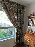 Full view of one panel hung on rod beside window