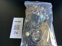 Front view of sealed bag showing mixed jewelry pieces