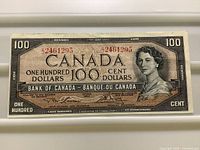 Obverse of 1954 Bank of Canada $100 note showing portrait, denomination, and serial number 2461295