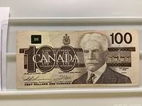 Obverse of Canadian $100 bill showing portrait, denomination, signatures