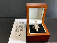 Ring front view showing marquise stone and accent stones