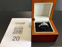 Ring in open presentation box with MaxSold sheet visible