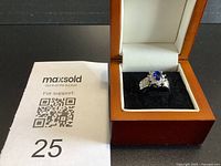 Ring in presentation box beside lot number card