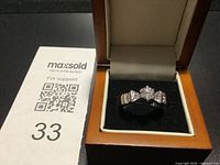 Ring in display box next to lot number card