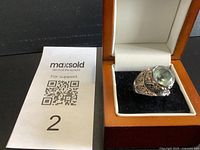 Ring in presentation box beside QR card showing overall appearance