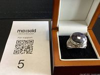 Ring in box next to lot tag, showing overall appearance