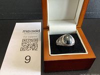 Ring in presentation box front view showing cabochon and setting