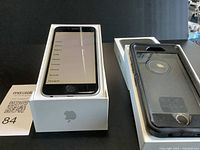 iPhone in box next to protective case
