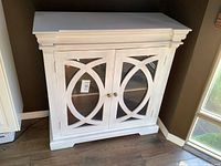 Front view of white cabinet with glass doors