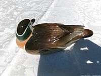 Resting duck figurine left side profile