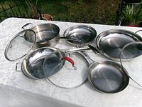 overview of all five pans with lids spread on table