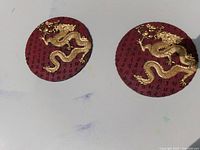 Two round resin dragon plaques front view