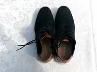 Top view of both shoes showing laces, knit uppers and logo inside