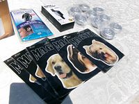 All items laid out on table: diffuser box, hearing amplifier, car charger, magnets, tap lights