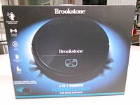 Front of sealed Brookstone 3-in-1 robotic floor cleaner box
