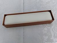 Closed bronze-tone rectangular jewelry box