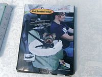 Front view of boxed Solvit pet booster seat showing product image and features