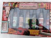 Front of sealed Roadhouse hot-sauce assortment box showing seven bottles