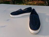 Full view of both sneakers showing uppers, soles and overall color