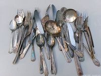 Overhead view of mixed silver-plated forks, spoons and knife
