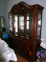 Full view of cherry wood china cabinet hutch showing both upper glass display and lower buffet