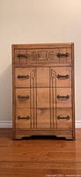 Front view of refinished wooden Art Deco dresser showing drawer layout and Bakelite pulls