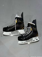 Overall view of both Bauer Supreme skates showing boot, holder and runner