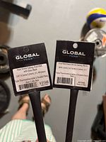 Two tagged Global dual-wall heat shrink tubes showing size labels