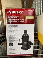 Front of boxed Husky 12 ton welded bottle jack showing product image and specs