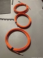 Three coils of orange Raychem heating cable on floor