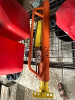 Full view of orange hydraulic t-post pounder on shelf