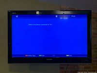 Front view of Sharp Aquos TV powered on displaying menu