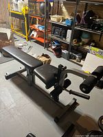 Full view of weight bench with leg developer and surrounding equipment