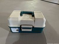 Closed Woodstream tackle box exterior showing brand and handle