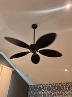 Full view of installed Hunter ceiling fan operating, showing five blades and downrod
